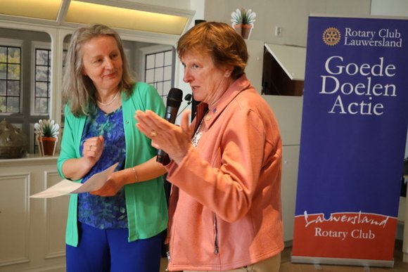 Gouverneur Francie Kaaijk (rechts) overhandigde aan inkomend-voorzitter Yvonne te Nijenhuis de traditionele feestdonatie van het district.