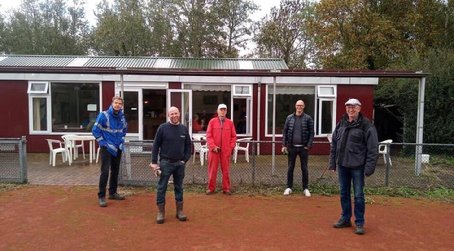 A group of men standing outside a building

Description automatically generated with medium confidence