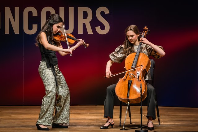 Two women playing instruments on a stage

AI-generated content may be incorrect.