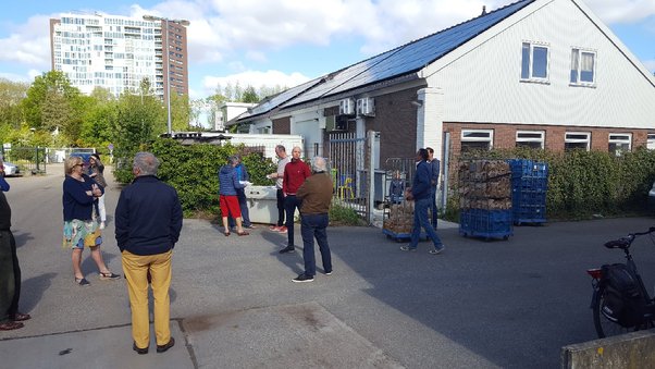 A group of people standing outside of a building

Description automatically generated