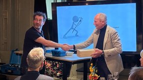 A person shaking hands with another person in front of a screen

AI-generated content may be incorrect.